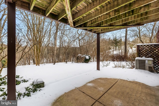 yard layered in snow featuring central AC