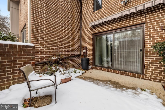 view of snow covered property entrance