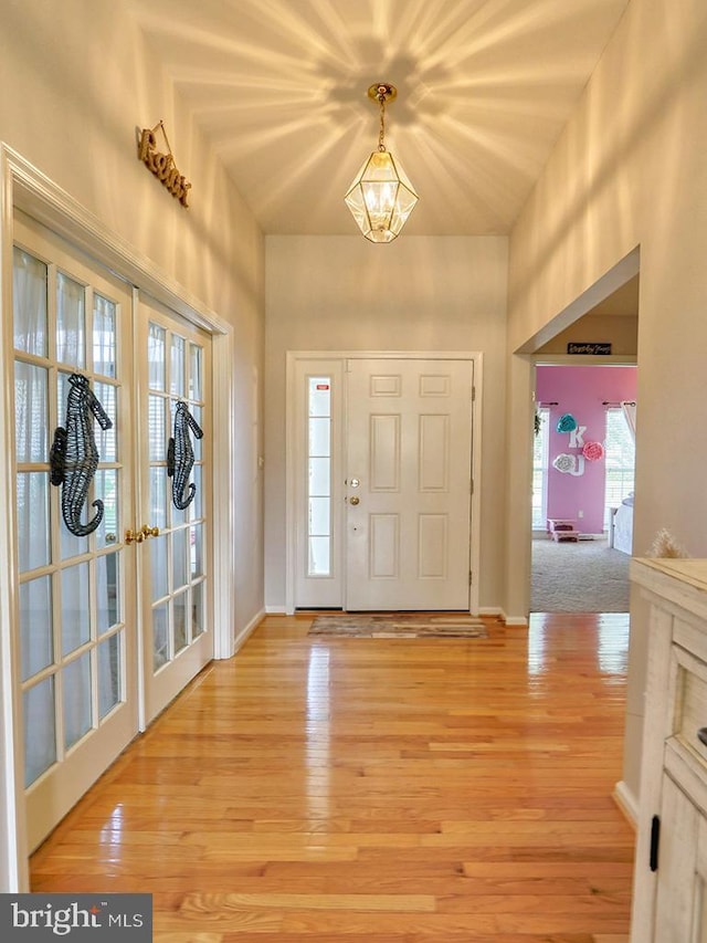 foyer with french doors and wood-type flooring