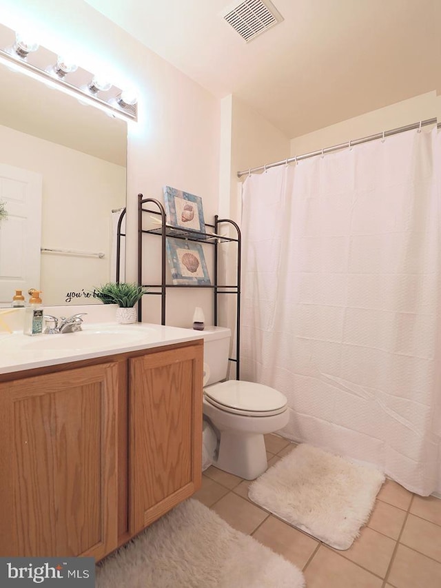 bathroom featuring toilet, tile patterned floors, and vanity