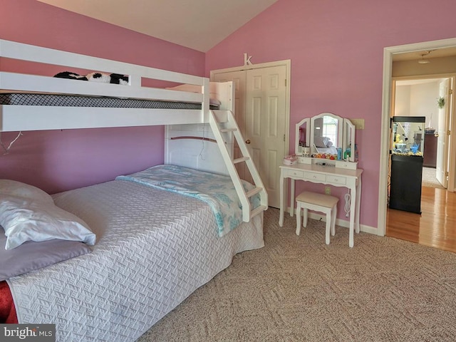 bedroom with lofted ceiling and carpet floors