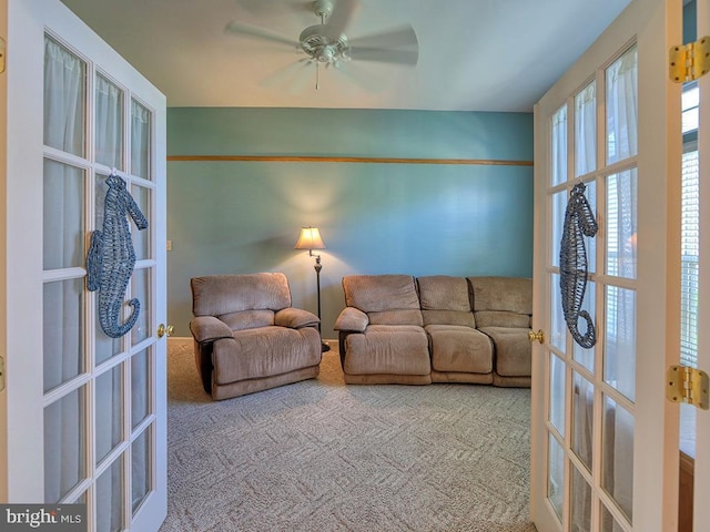 living room with french doors, carpet floors, and ceiling fan