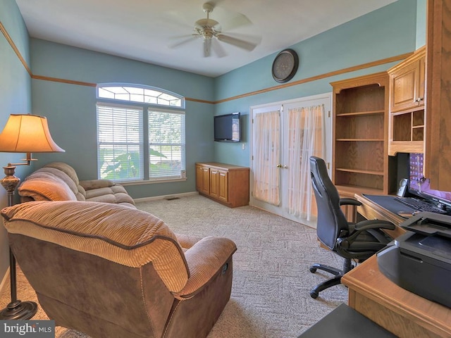 carpeted home office with ceiling fan