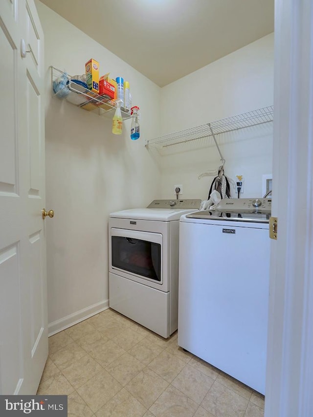 clothes washing area with washing machine and clothes dryer