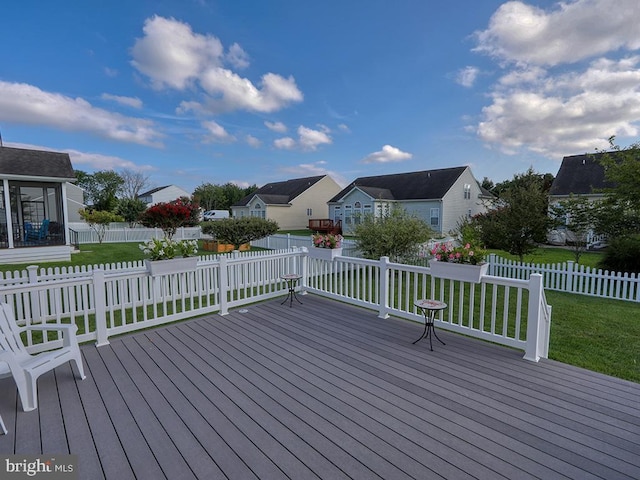 wooden deck featuring a yard