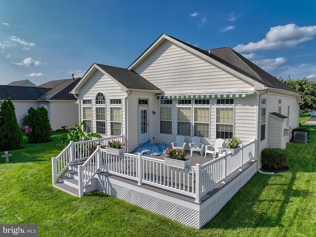 back of house featuring central air condition unit, a lawn, and a wooden deck