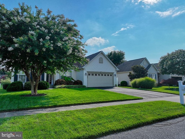 view of front of property featuring a front lawn and a garage