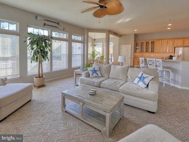 living room featuring ceiling fan and light colored carpet