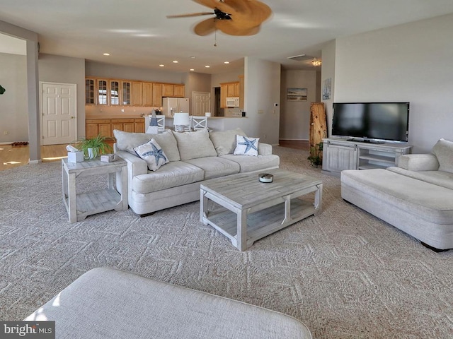 living room featuring ceiling fan and light carpet