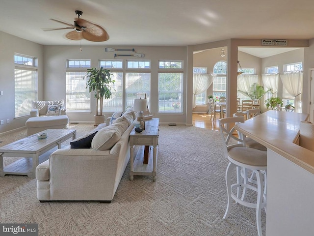 living room with ceiling fan and light carpet