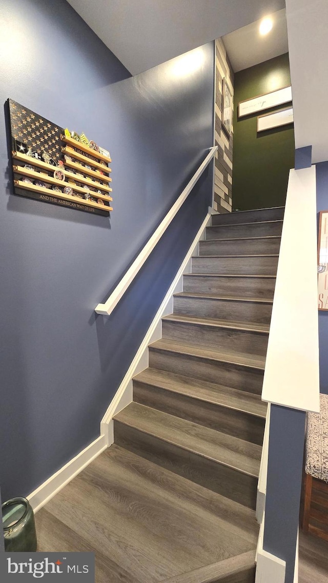 stairway with hardwood / wood-style flooring