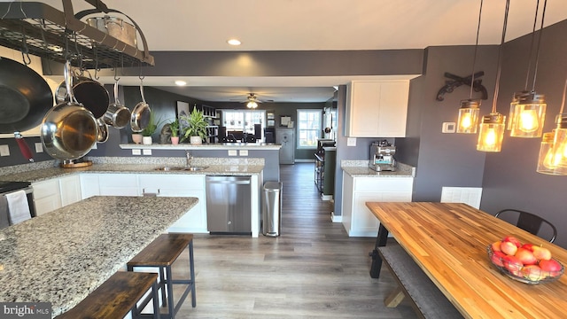 kitchen with dishwasher, white cabinetry, ceiling fan, and light stone counters