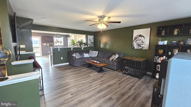 living room featuring hardwood / wood-style flooring and ceiling fan