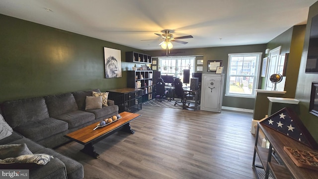 living room with ceiling fan and dark hardwood / wood-style flooring