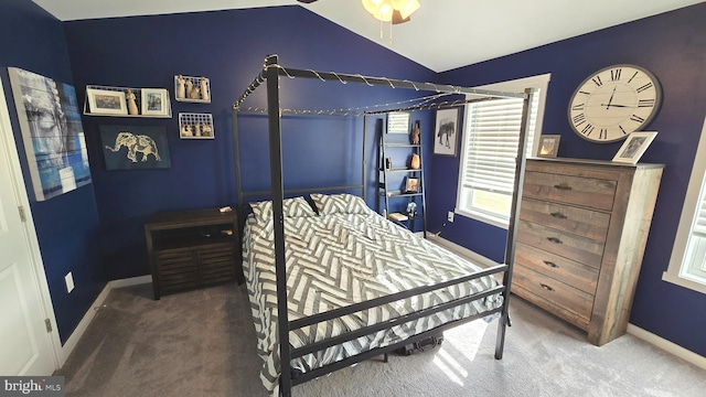 carpeted bedroom with vaulted ceiling and ceiling fan