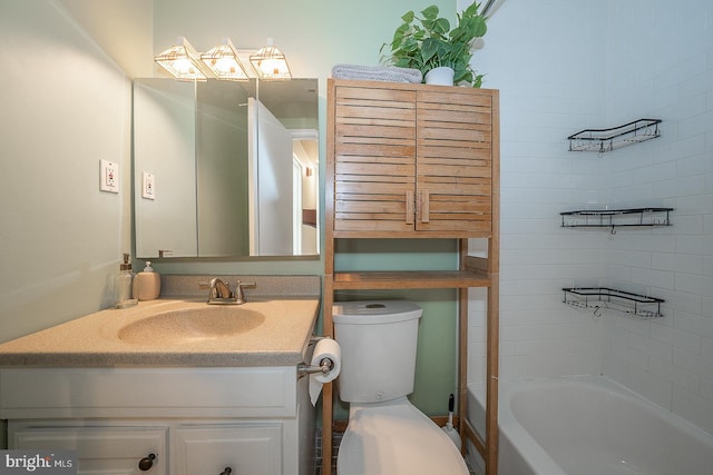 bathroom with vanity, toilet, and a bath