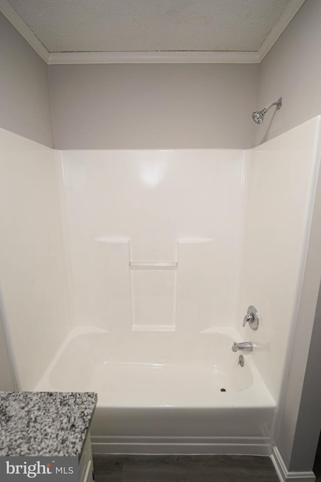 bathroom with hardwood / wood-style floors and shower / bathtub combination