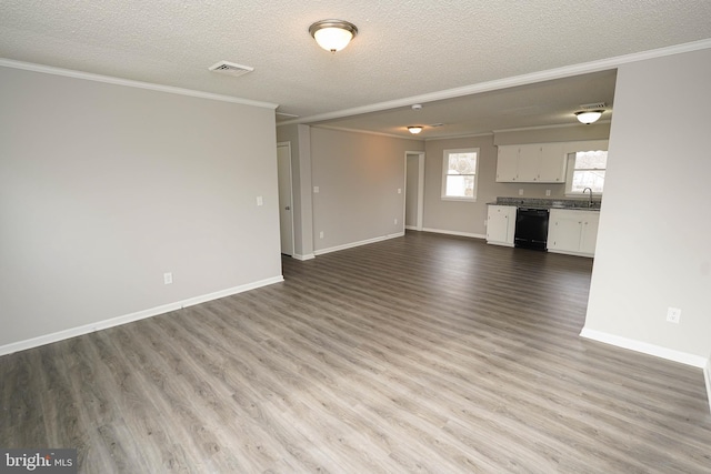 unfurnished living room featuring crown molding, sink, a textured ceiling, and light hardwood / wood-style flooring