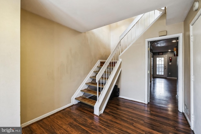 stairway featuring wood-type flooring