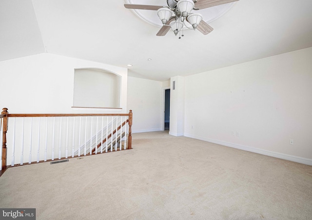 spare room featuring light carpet, ceiling fan, and lofted ceiling