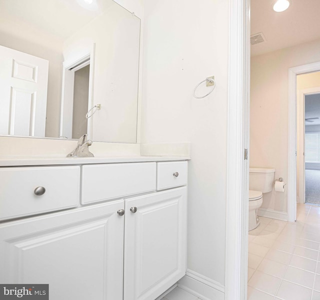 bathroom featuring tile patterned floors, vanity, and toilet