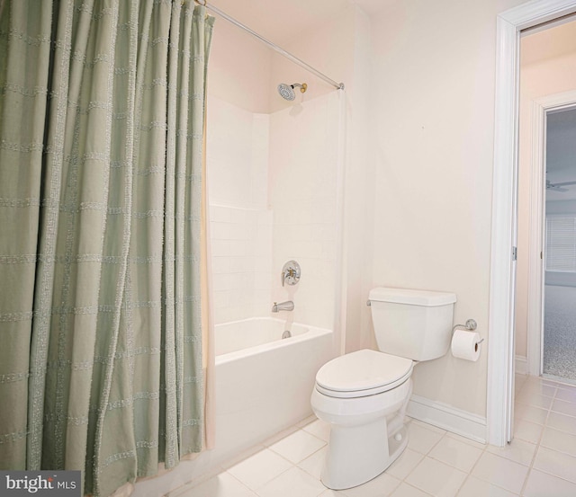 bathroom featuring tile patterned flooring, toilet, and shower / tub combo