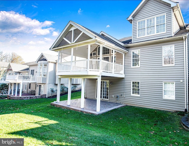 back of house with a yard and a patio