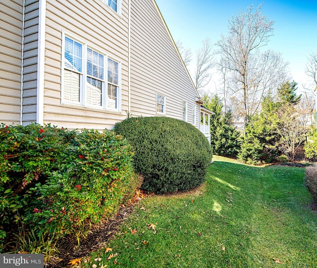 view of side of home featuring a lawn