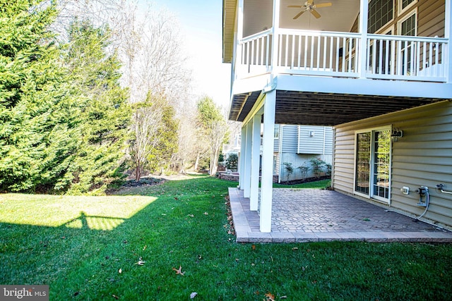 view of yard featuring ceiling fan and a patio