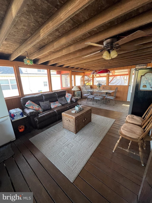 living room featuring hardwood / wood-style floors, plenty of natural light, and beamed ceiling