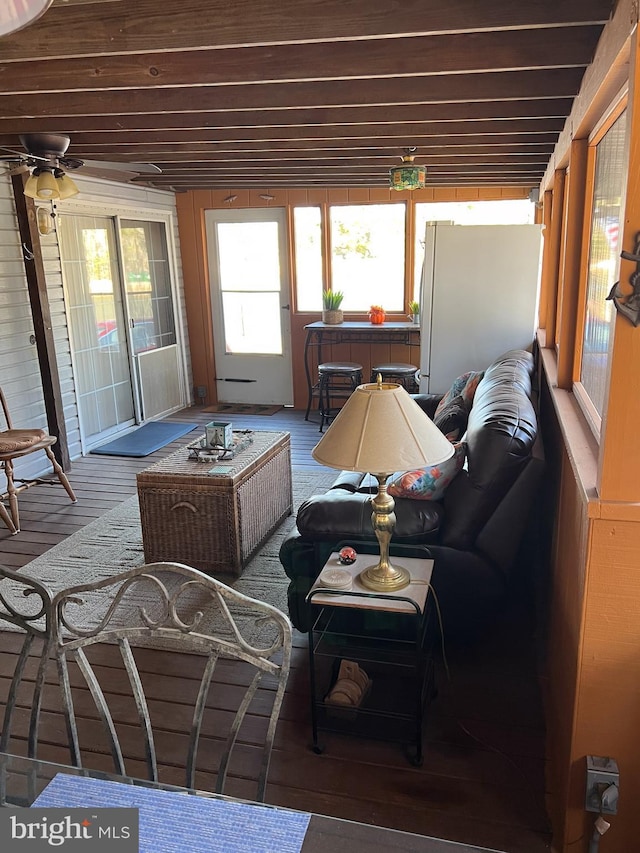 sunroom featuring ceiling fan