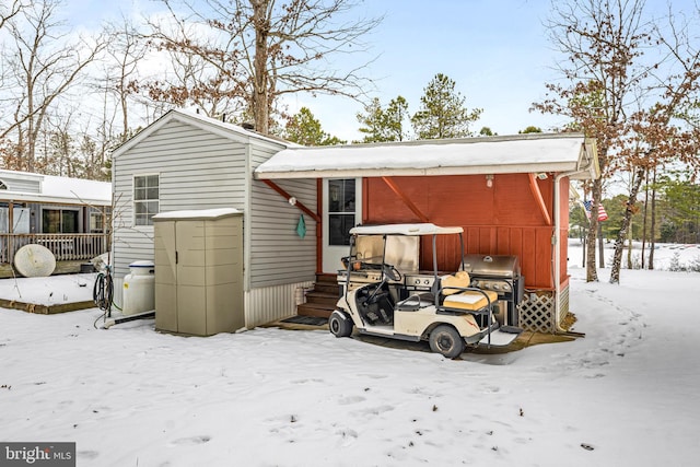 view of snow covered back of property