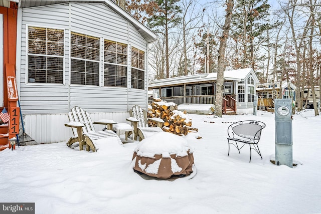 view of snow covered back of property