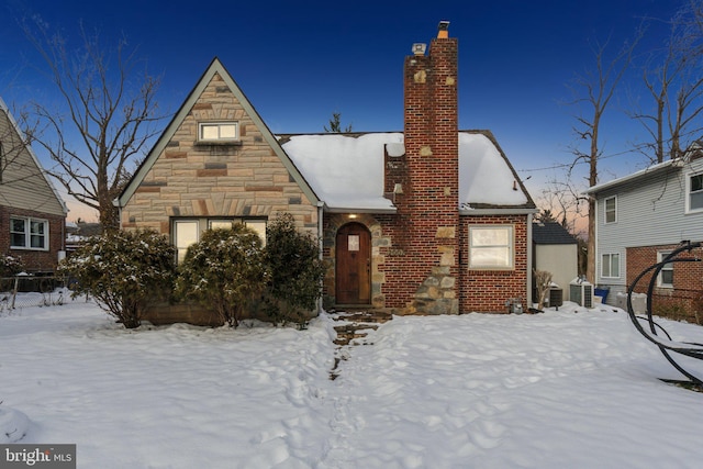 tudor-style house with cooling unit