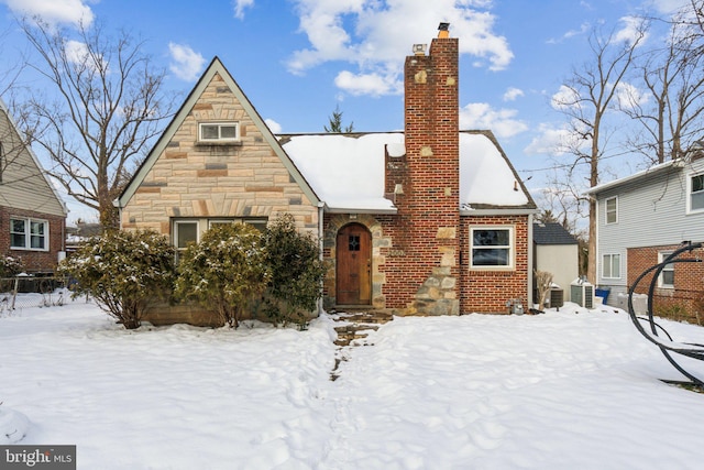 tudor house featuring cooling unit