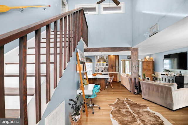 interior space with hardwood / wood-style flooring and a towering ceiling