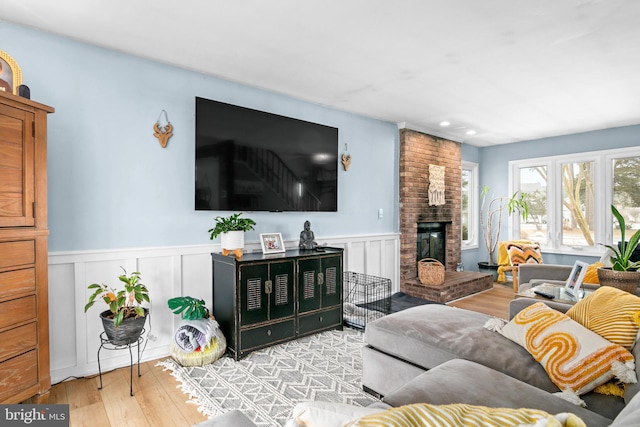 living room featuring a fireplace and light hardwood / wood-style floors