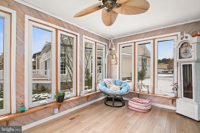 sunroom / solarium with ceiling fan