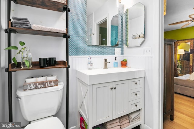 bathroom with toilet, ceiling fan, hardwood / wood-style floors, and vanity