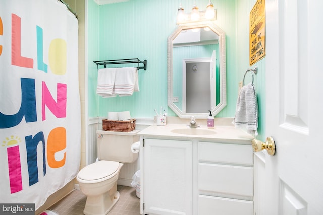 bathroom with curtained shower, tile patterned floors, vanity, and toilet