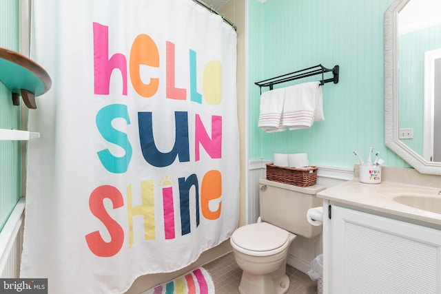 bathroom with toilet, a shower with curtain, tile patterned floors, and vanity