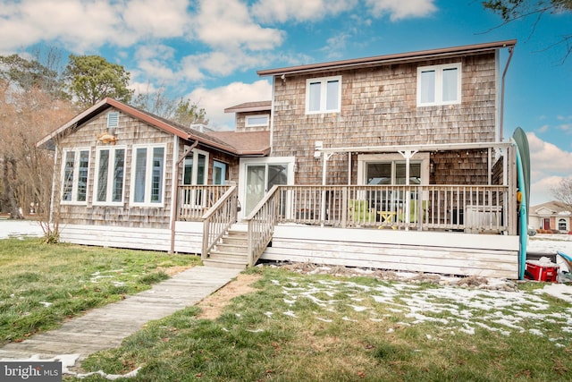 back of house featuring a deck and a lawn