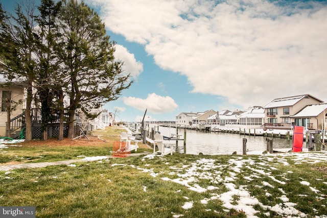 view of dock with a water view and a lawn