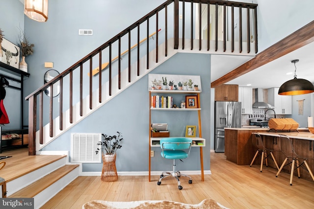 interior space with a high ceiling and hardwood / wood-style floors