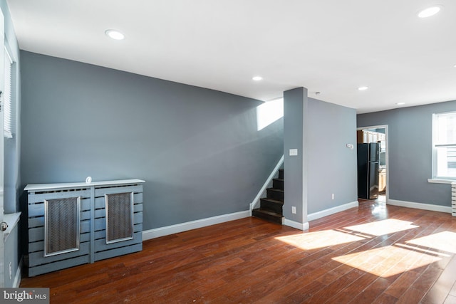 unfurnished living room featuring dark hardwood / wood-style floors