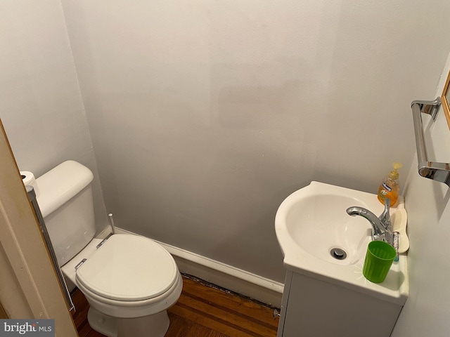 bathroom with vanity, hardwood / wood-style flooring, and toilet