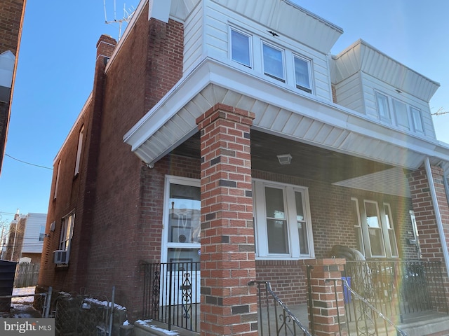 view of side of home with cooling unit and a porch