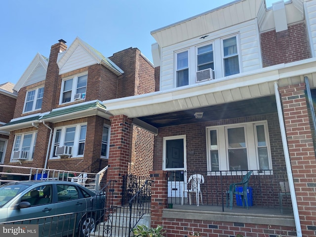 view of property with a porch and cooling unit