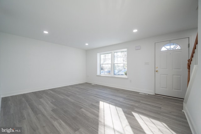 foyer entrance with light hardwood / wood-style floors and a wealth of natural light