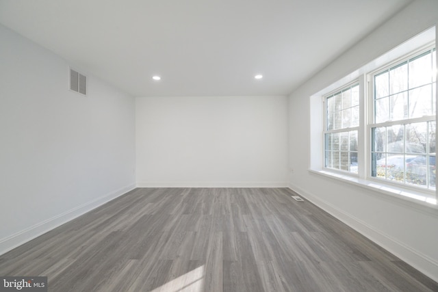 spare room with dark hardwood / wood-style flooring